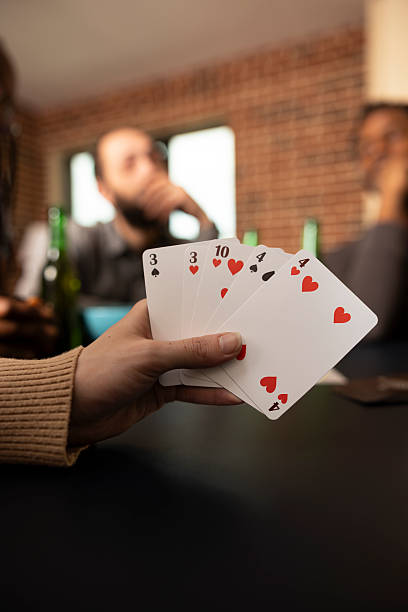 istock Caucasian individual holding cards at table 2222903169