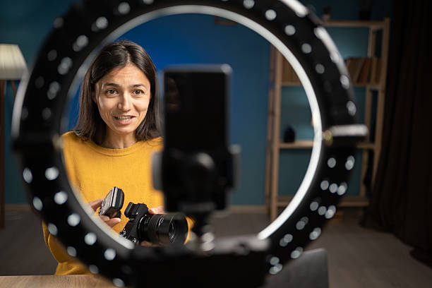 istock photographer content creator using smartphone for social media, vlogging and livestreaming. Influencer photographer hosting educational podcast 2222904202