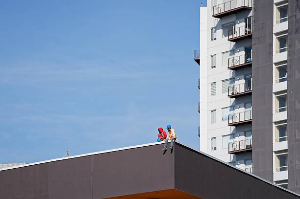 Men installing a new roof on a house.