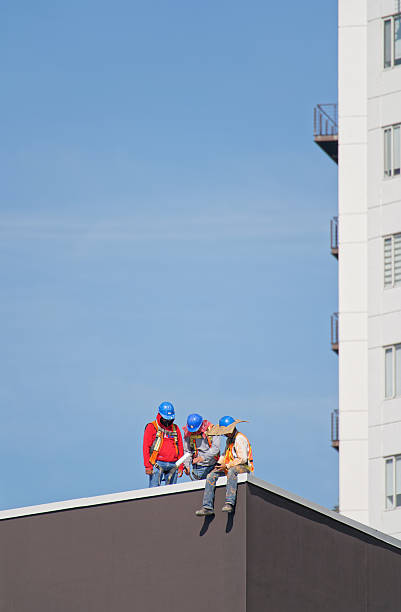 Two roofers applying \