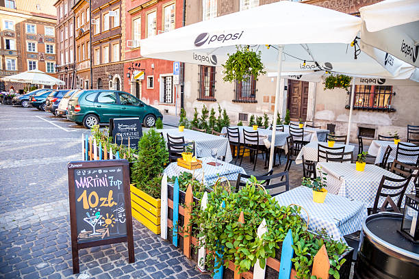Outdoor Cafe Seating. Chairs and tables. Old tourist town in summer. Poland, Warsaw - June 28, 2019.