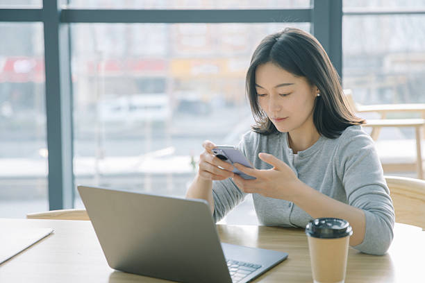 istock Businesswoman checking smartphone at work 2222911018