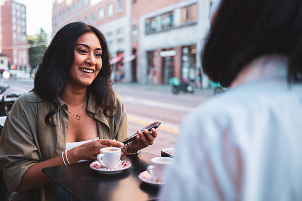istock Two friends enjoying coffee and conversation at a cafe in milan 2222911241