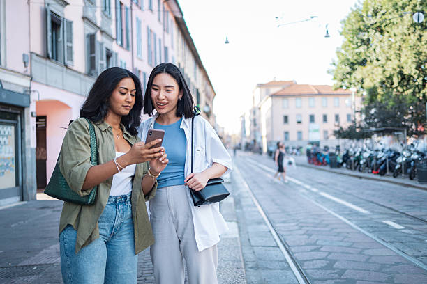 istock Two tourists using smartphone are walking in milan, italy 2222911278