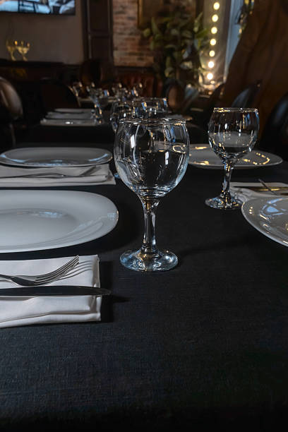 Elegant table setting for a gourmet dinner celebration with fine glassware and stylish cutlery in a modern restaurant ambiance