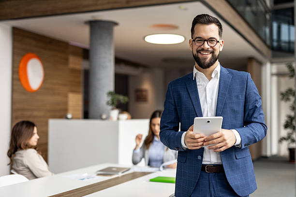 istock Confident businessman holding tablet in modern office 2222913271