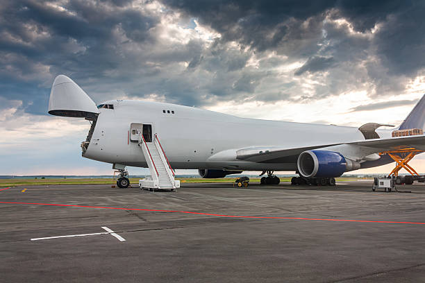 istock Loading cargo into wide body freight aircraft with an open nose hatch 2222913397