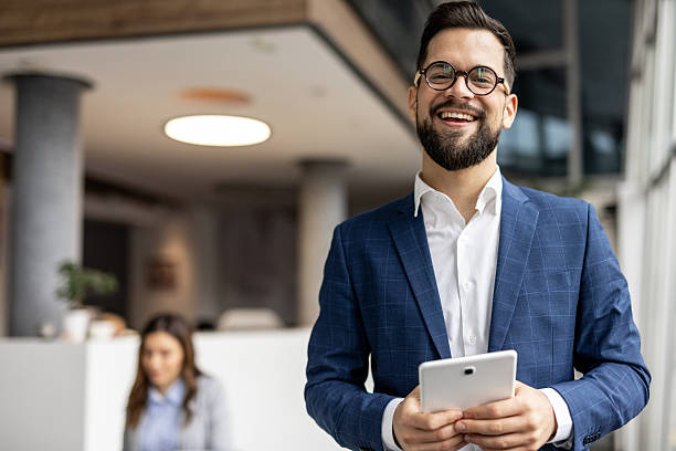 istock Confident businessman smiling with digital tablet 2222913638