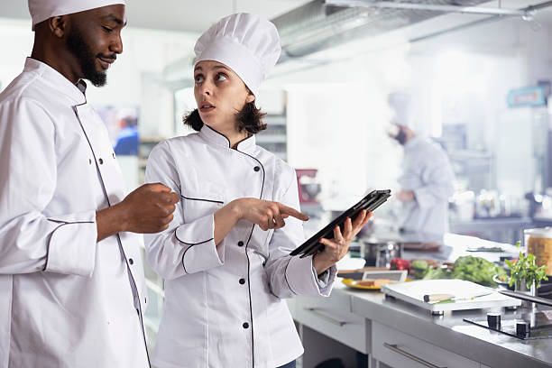 istock Diverse chefs in uniform using a tablet to find new cooking combinations ideas 2222914172