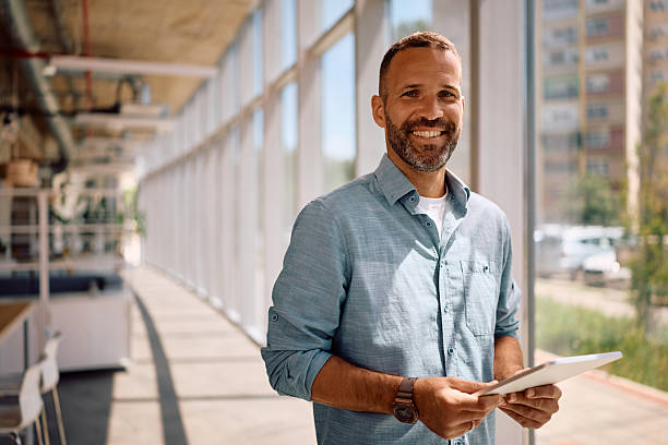 istock Happy businessman with digital tablet in the office looking at camera. 2222914204