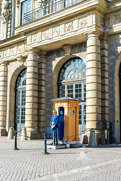 Stockholm, Sweden -  May 30 2025: Palace guard in traditional uniform next to sentry box