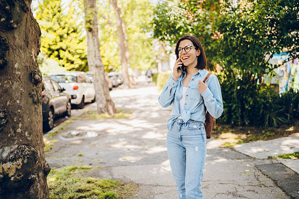 istock Young woman using phone and enjoy in walking 2222915848