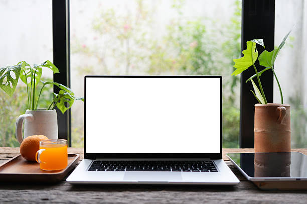 istock laptop and orange juice and tablet 2222915914