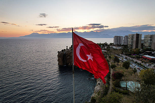 Antalya Clock Tower and Yivli Minaret, Mediterranean Sea and the Taurus Mountains on background. Antalya, Turkey