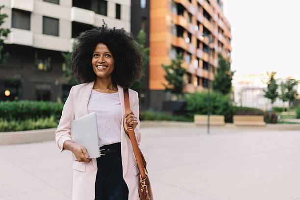 istock Professional woman smiling in modern cityscape 2222918765