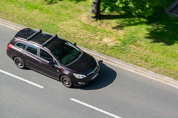 Ostrava, Czechia - May 21, 2025: Opel Vauxhall Astra J Caravan estate car, motion blur effect