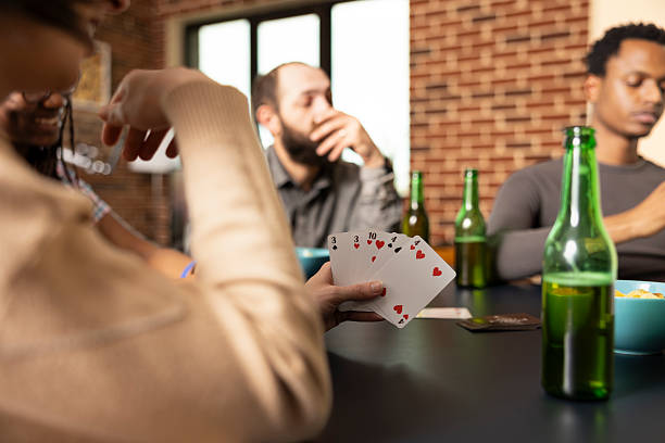 istock Woman playing cards with diverse friends 2222919113