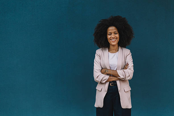 istock Confident Woman Smiling Against Dark Blue Background 2222919153