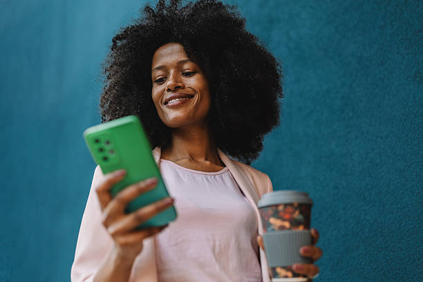 istock Woman enjoying her smartphone and coffee delight 2222919596