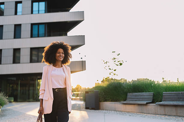 istock Confident woman walking in a modern cityscape 2222919784