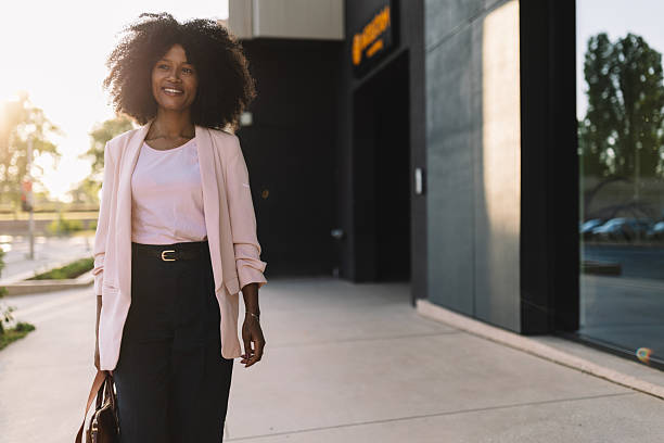 istock Smiling woman with briefcase, walking into office 2222920075