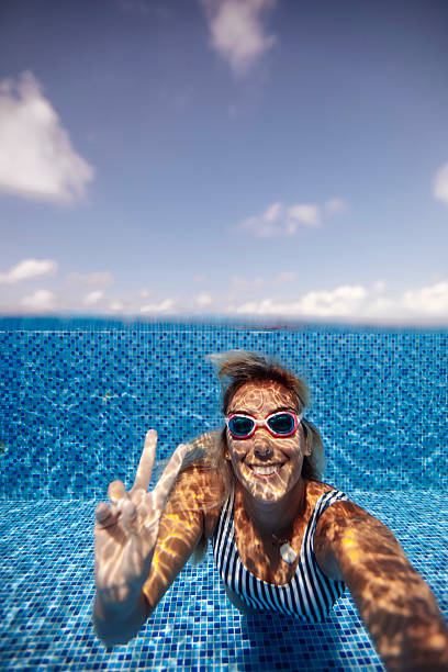 istock Woman in Pool with Peace Gesture 2222920950