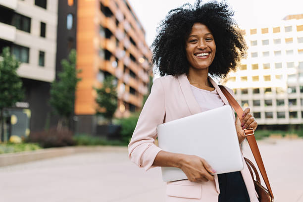 istock Happy woman holding laptop in a modern setting 2222921039