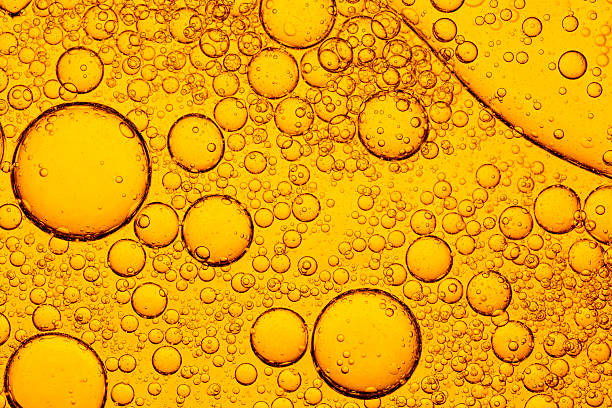 istock Macro close up yellow drink bubble texture,Focus boiling yellow oil spread widely bubble texture full frame and macro many various droplets,Cooled glass of beer close-up.  Small water drops on cold surface of beer glass. 2222923947