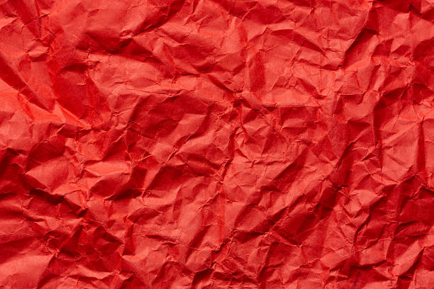 istock Red crumpled paper texture macro,Red crumpled paper as a texture or background. Bright red crumpled paper for backgrounds, design, packaging, holiday cards or creative projects, for valentines, and visual compositions. 2222924058