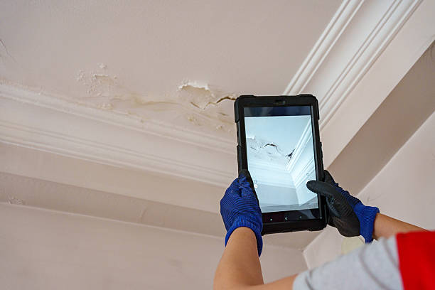 Worker fix leaking pipe in ceiling ,close-up of a stain on the ceiling