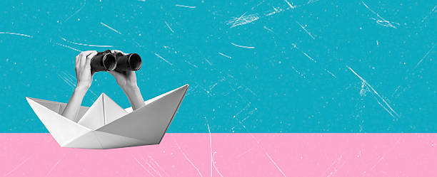 istock Art collage, Hands holding binoculars from a paper boat on a bright blue and pink background during a creative artistic moment 2222925271