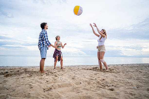 istock Friends playing beach volleyball on a cloudy day 2222925327