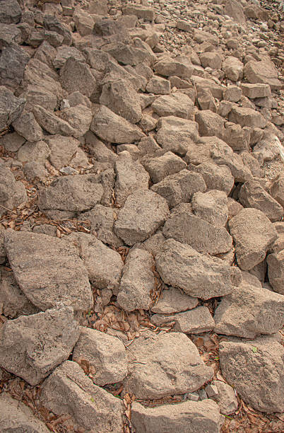 istock rough natural rocks with dry leaves between them 2222928502
