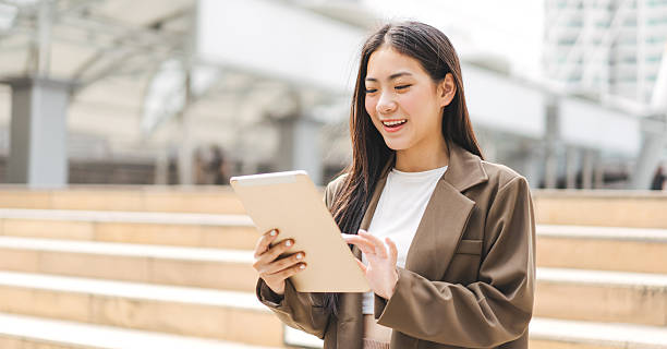 istock Business asian woman using digital tablet for internet browsing in the city 2222932468
