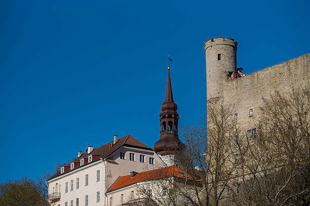 Tallinn, Estonia - May 05 2025: Tallinn’s medieval charm under a clear blue sky. Featuring historic Toompea Castle and a striking church spire.
