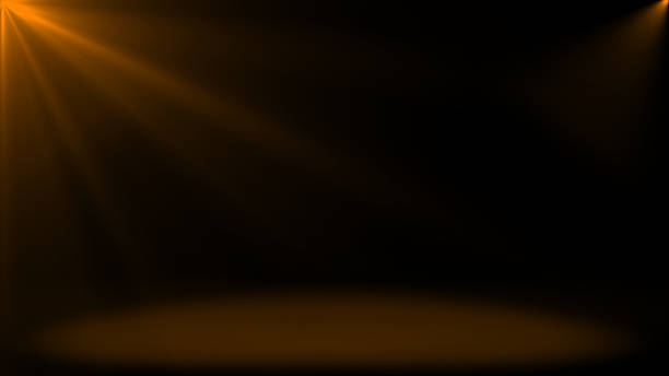 istock Abstract shinny light rays falling on floor, Orange optical flares dark background 2222933544
