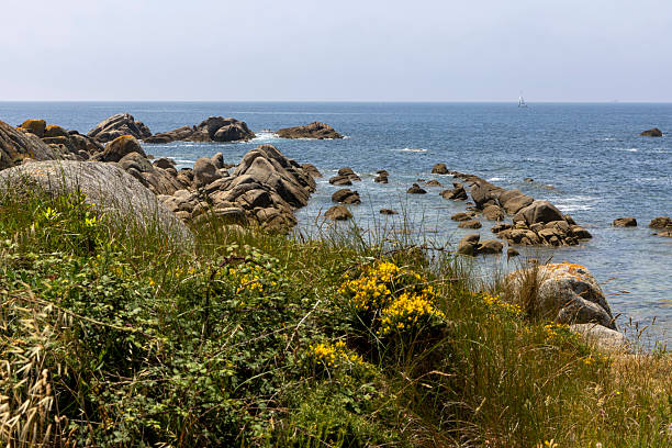 istock A rocky shoreline with a small boat in the water 2222933698
