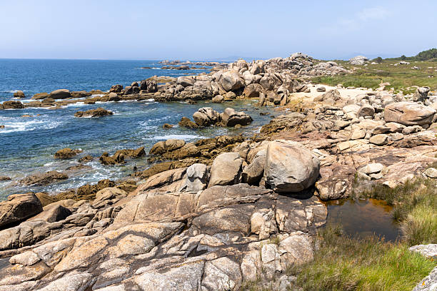istock A rocky shoreline with a small boat in the water 2222935556