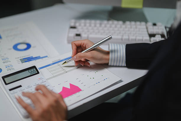 istock Businesswoman working with financial data in the office, analyzing charts and using calculator 2222936323