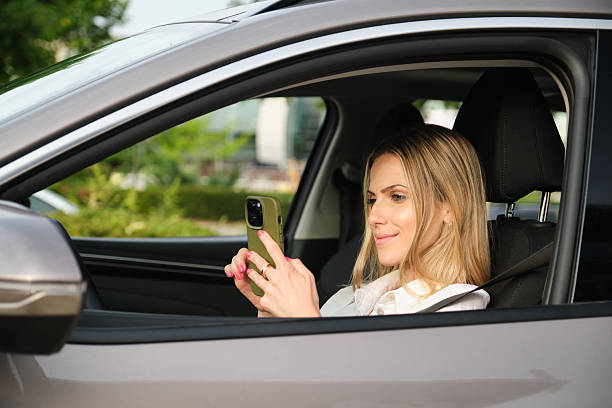 istock Businesswoman using smartphone in electric car 2222936857