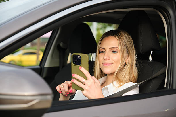 istock Businesswoman using smartphone while sitting in electric car 2222937066