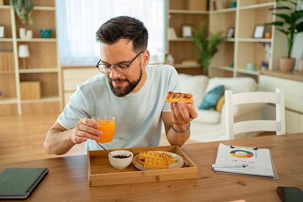 istock Freelancer enjoying breakfast and working from home 2222937910