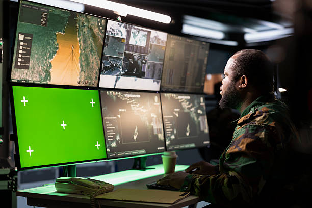 istock Soldier managing communications networks, looking at chroma key monitors 2222939762