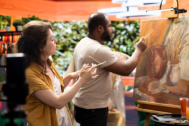 istock Woman painter filming her colleague during his creative process 2222941435