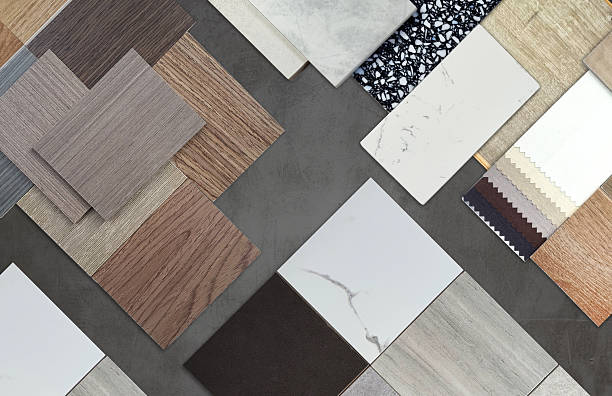 istock Diverse interior design material samples: wood veneer, laminate, marble, stone tile, terrazzo, fabric, artificial stone swatches placed on black cement background. 2222942306