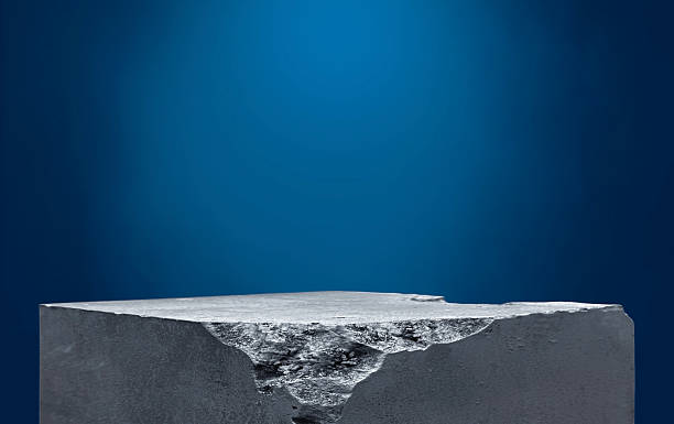 istock Rock stone podium stand for display product especially cosmetics on dark blue background with smoke float above. raw concrete stand well free space for displayed product with light from above. 2222942378