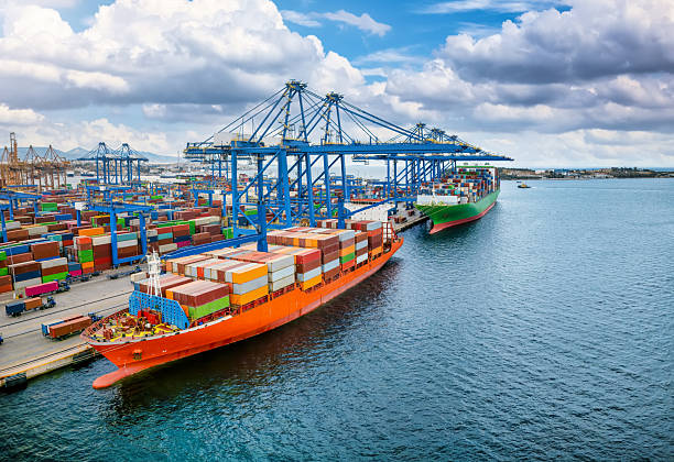istock A large container cargo vessel is beeing loaded and unloaded by big cranes 2222943619
