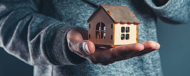 istock hand with house model business concept 2222944957