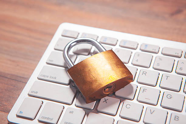 istock padlock with a laptop on a wooden background. 2222944960