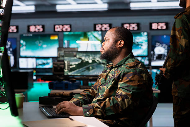 istock Military dispatcher managing communications networks, looking at screens 2222945201